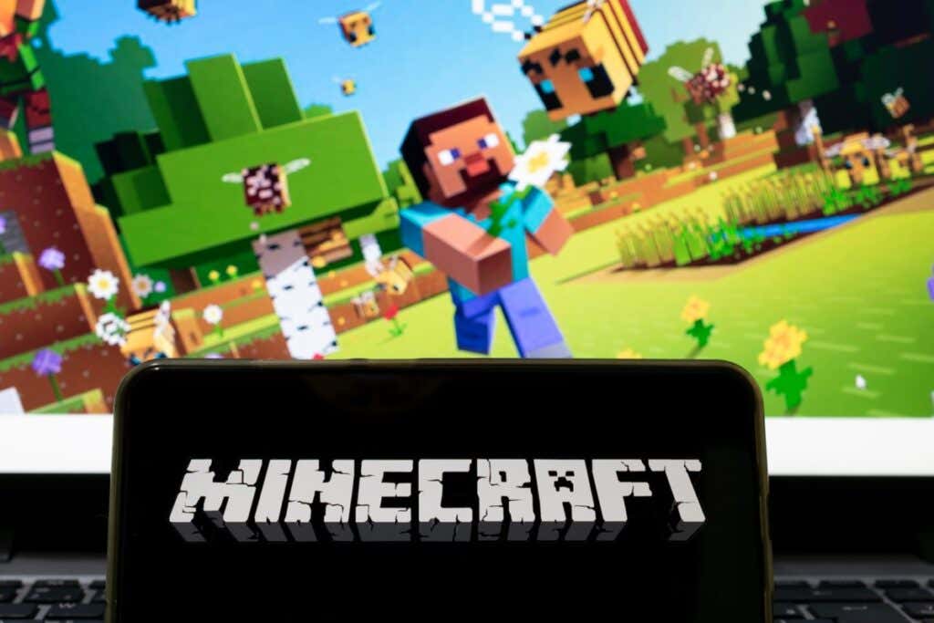 How to Download and Install Mods in Minecraft image - São Paulo, Brazil - April 1, 2021: cell phone with the name of the game Minecraft and the background screen blurred with the game application. Selective focus.