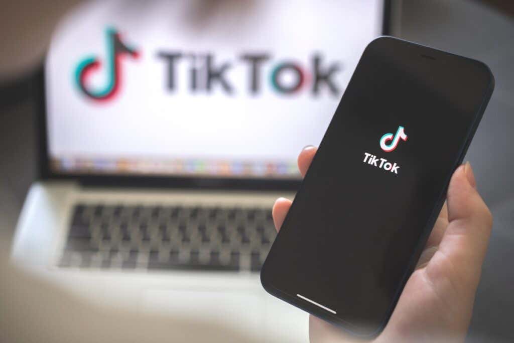 How to Use Text to Speech on TikTok image - Kharkov, Ukraine - August 12, 2021: Tiktok social media app. Woman using smartphone with tiktok application. Brand logo photo
