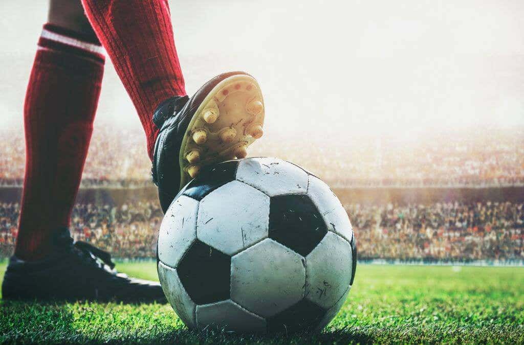 A soccer player's right foot on a soccer ball