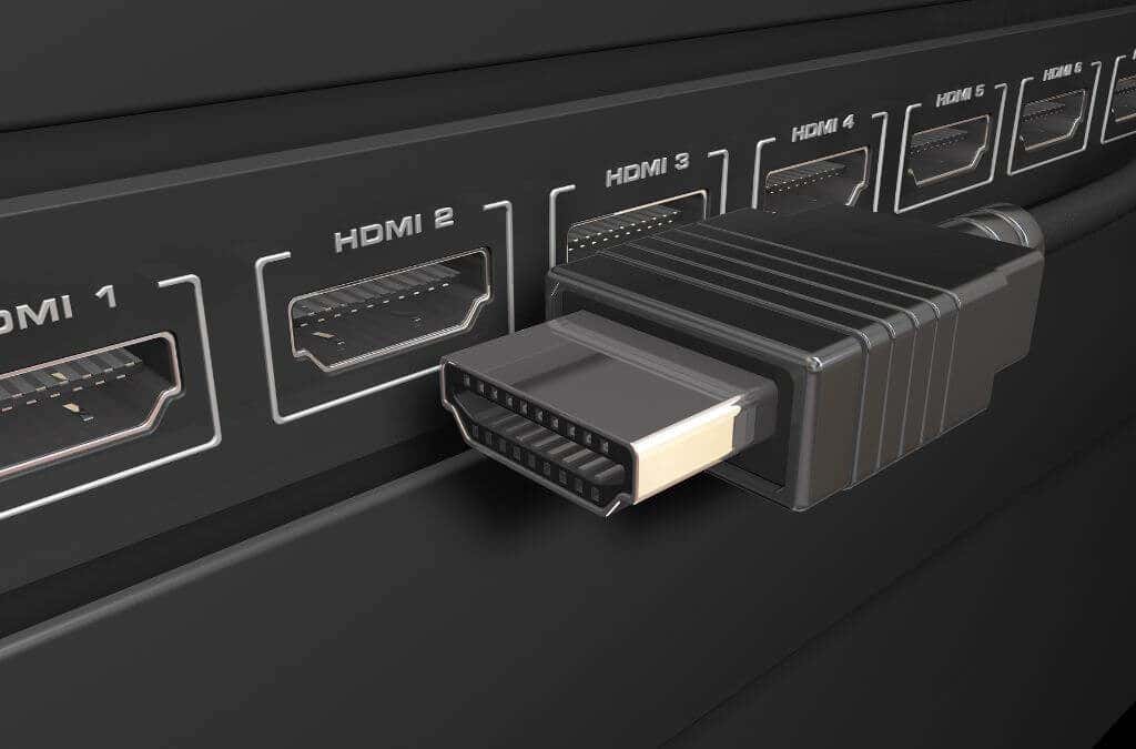 An HDMI cable beside multiple HDMI inputs