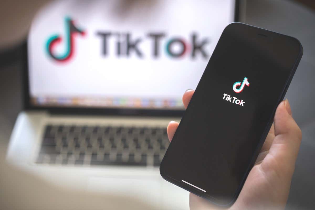  - Kharkov, Ukraine - August 12, 2021: Tiktok social media app. Woman using smartphone with tiktok application. Brand logo photo