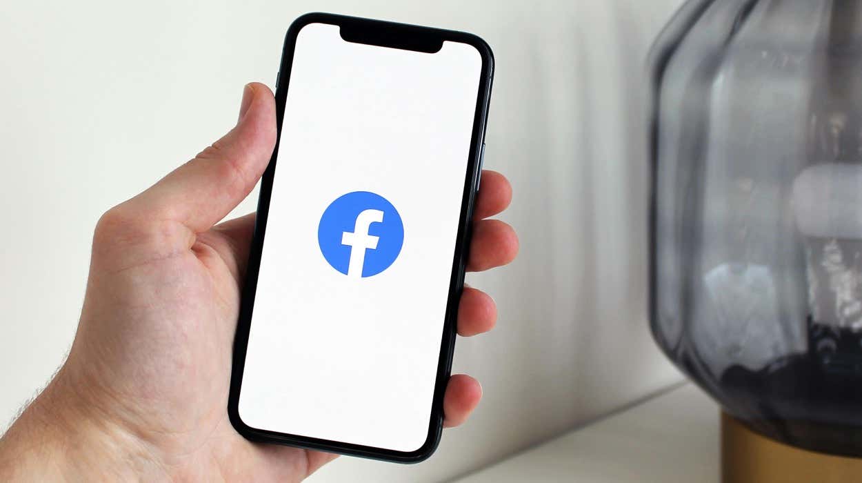 The Facebook logo prominently shown on a smartphone.